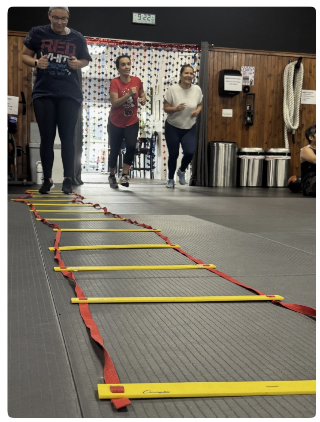 Members moving through an agility ladder exercise